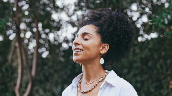woman breathing and smiling outdoors