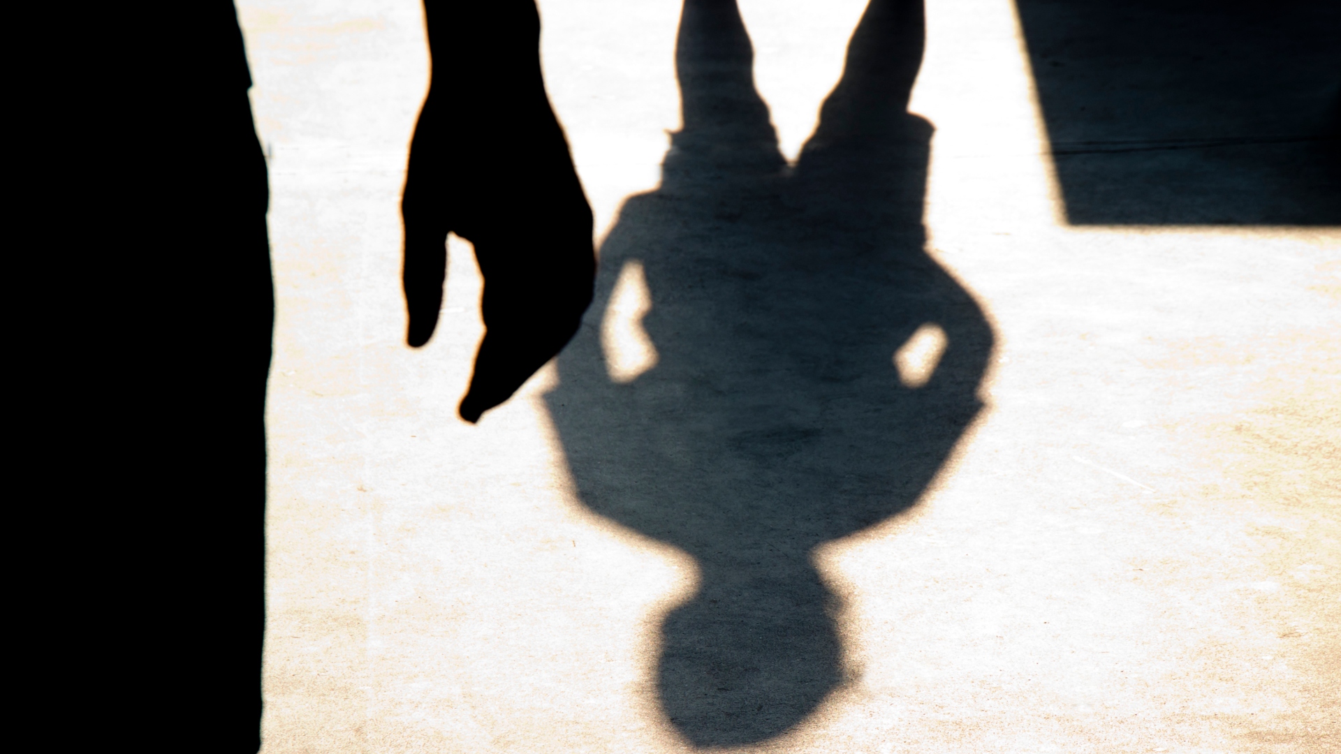 Blurry shadow silhouette of two boys confronting each other in school yard
