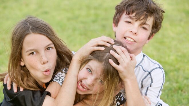three kids roughhousing