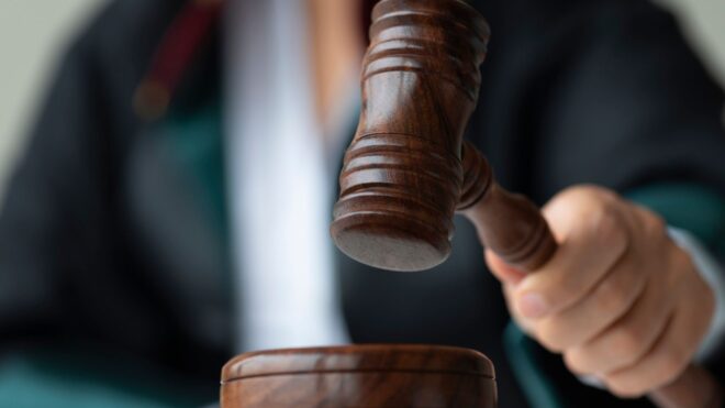 A female judge holding a wooden gavel