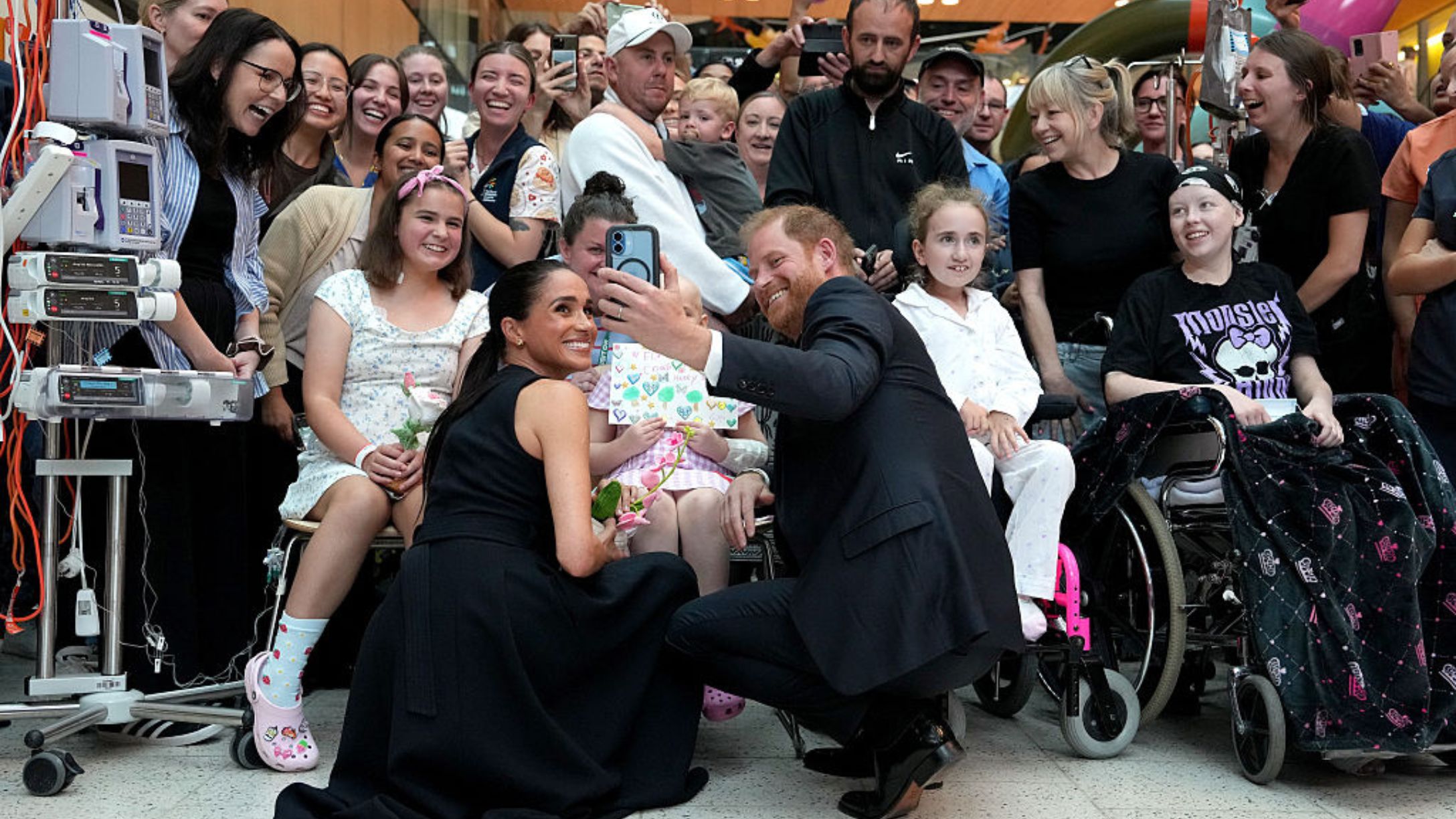 Meghan Markle and Prince Harry pose for a selfie with children and their families during a visit to the Royal Children’s Hospital on April 14, 2026 in Melbourne, Australia