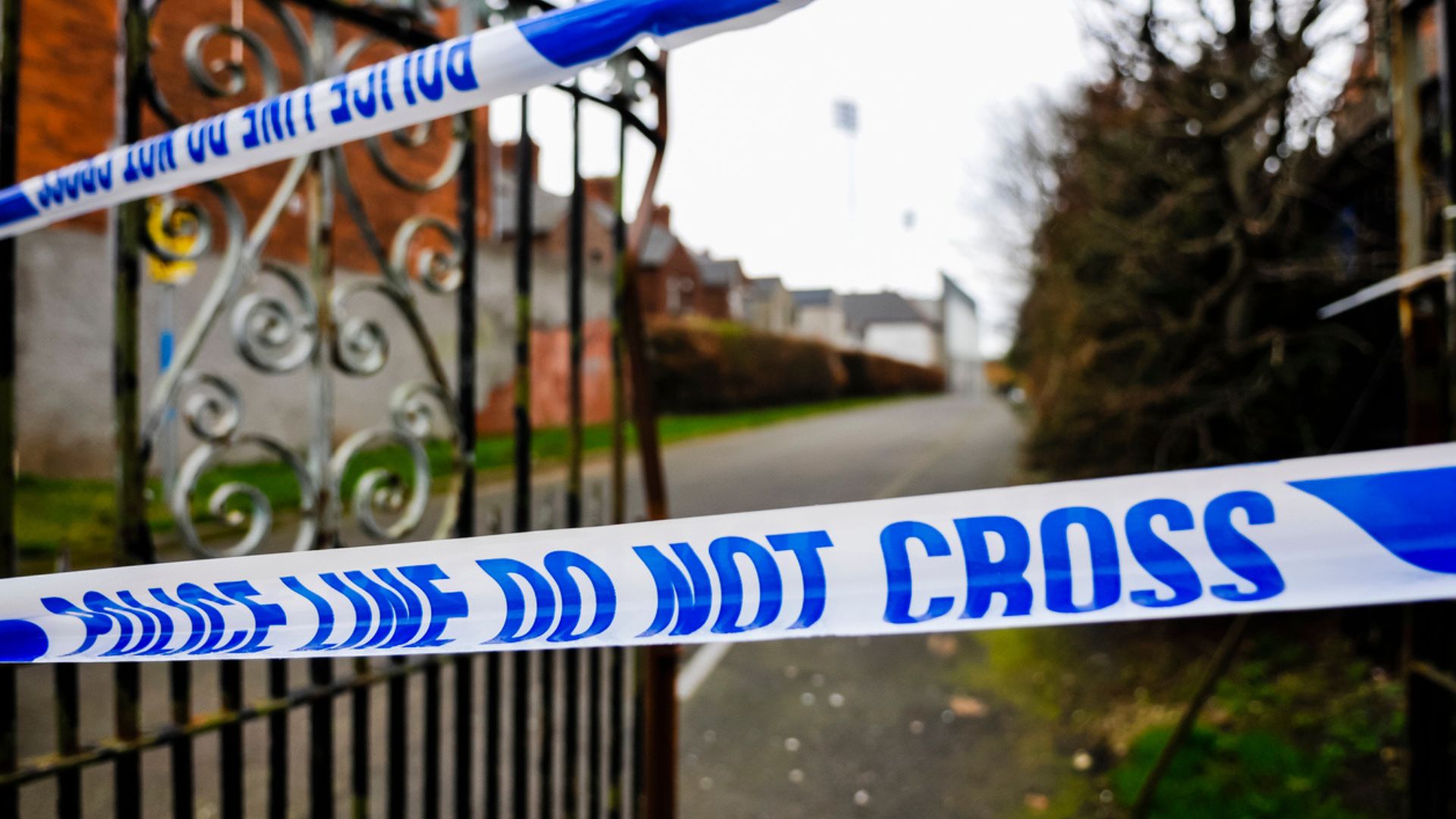UK Police crime tape outside a community gate in the UK