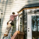 man-repairing-siding