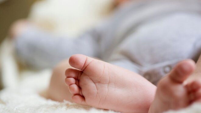 An upclose shot of baby feet while the infant sleeps