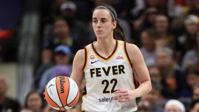 Caitlin Clark #22 of the Indiana Fever brings the ball up the court against the Dallas Wings
