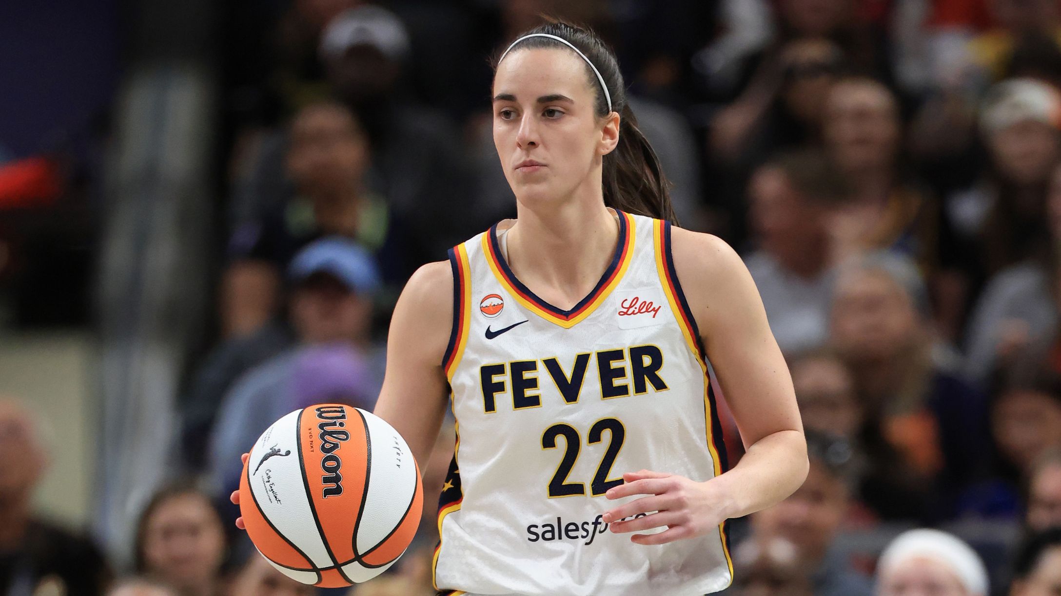 Caitlin Clark #22 of the Indiana Fever brings the ball up the court against the Dallas Wings
