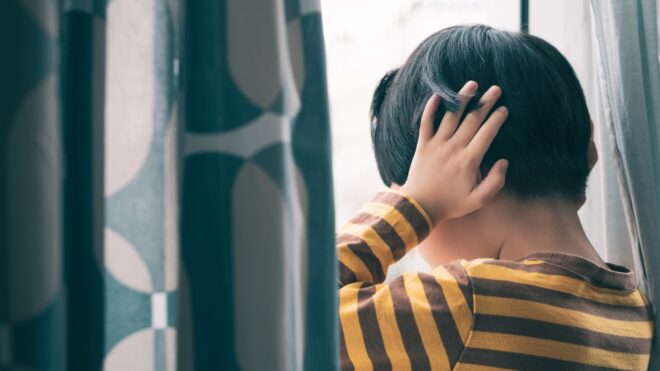 boy looking out window