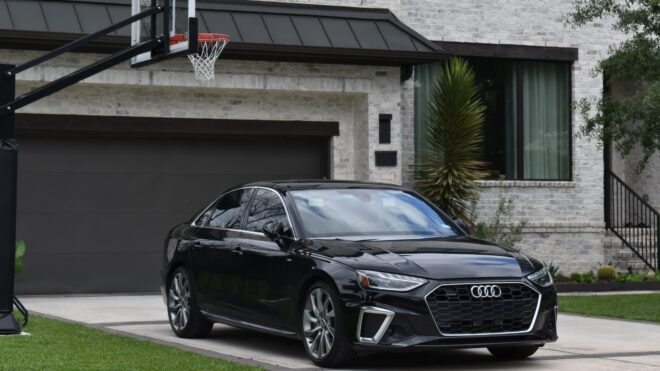 A car parked in the driveway of a house