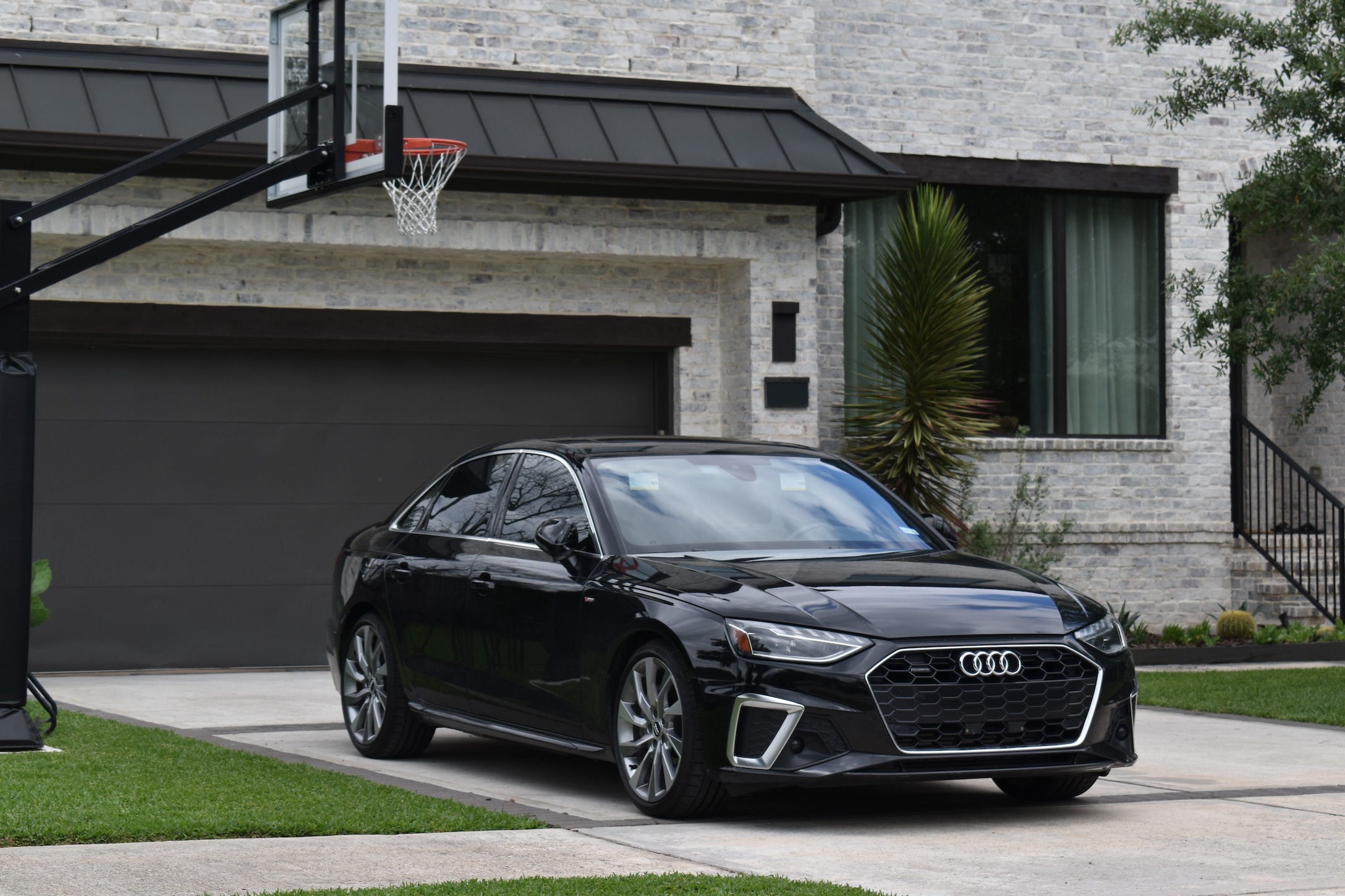A car parked in the driveway of a house