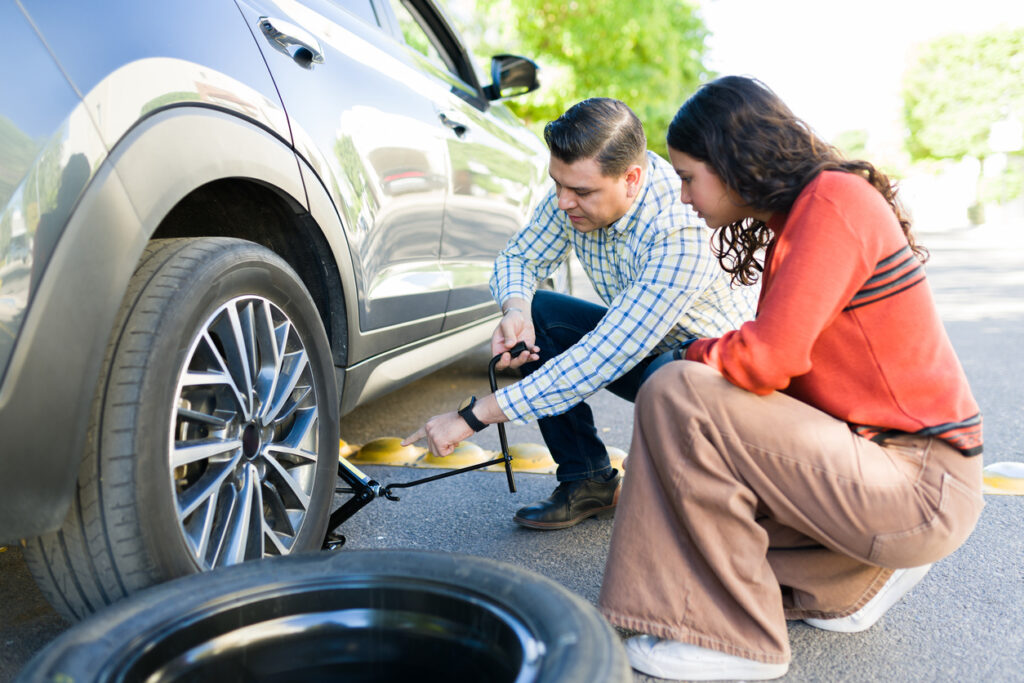 dad and daughter changing tire