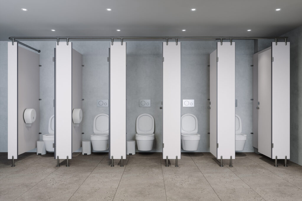 White Public Restroom Stalls With Toilets In Modern Clean Interior