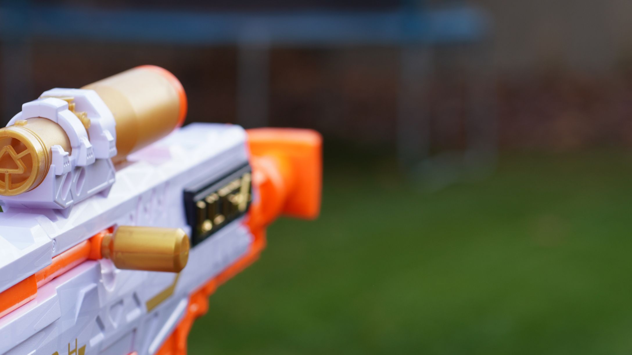 A close-up shot of someone pointing a toy rifle outdoors