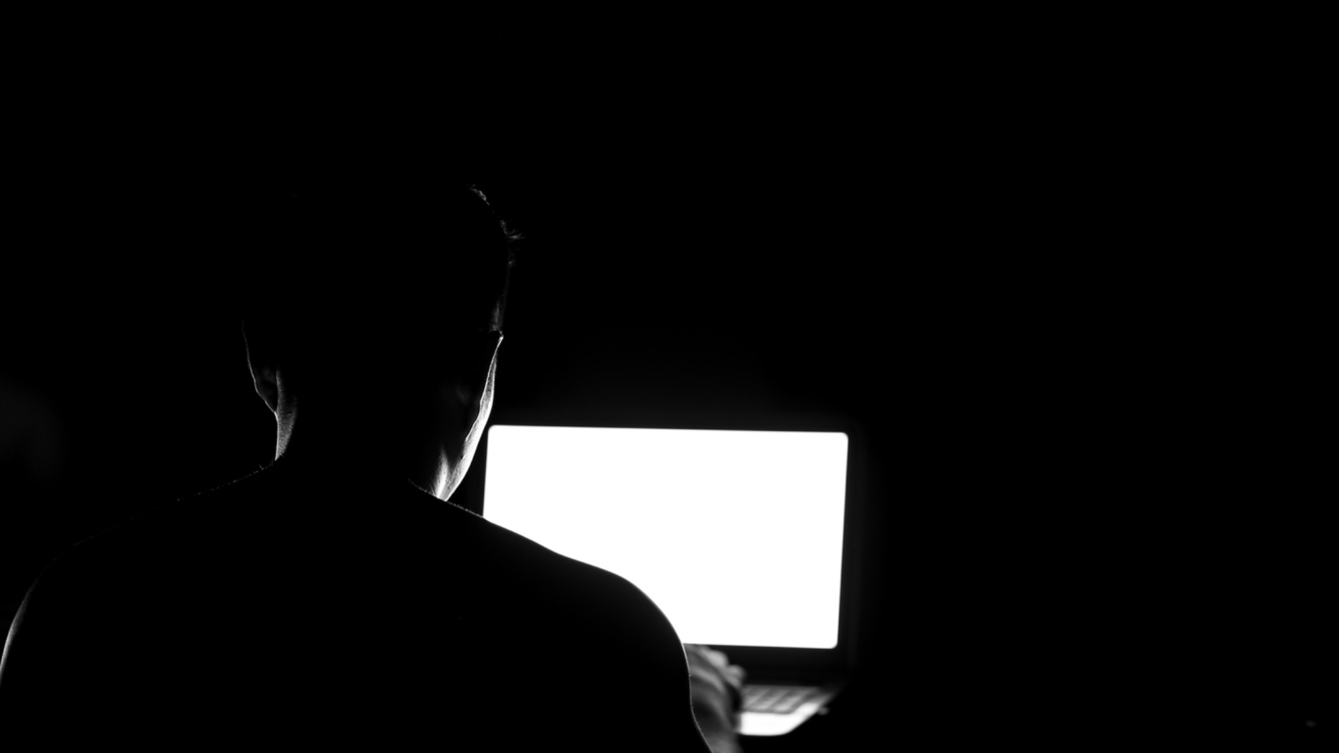Man Behind Computer Screen in the Dark