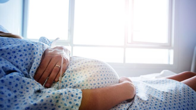 Close-up of a pregnant woman's stomach in the hospital