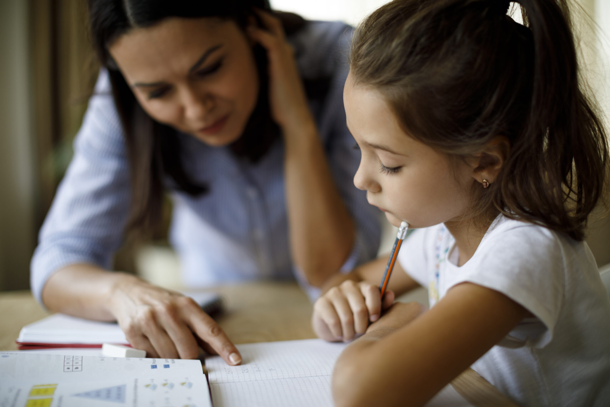 mom helping daughter with homework
