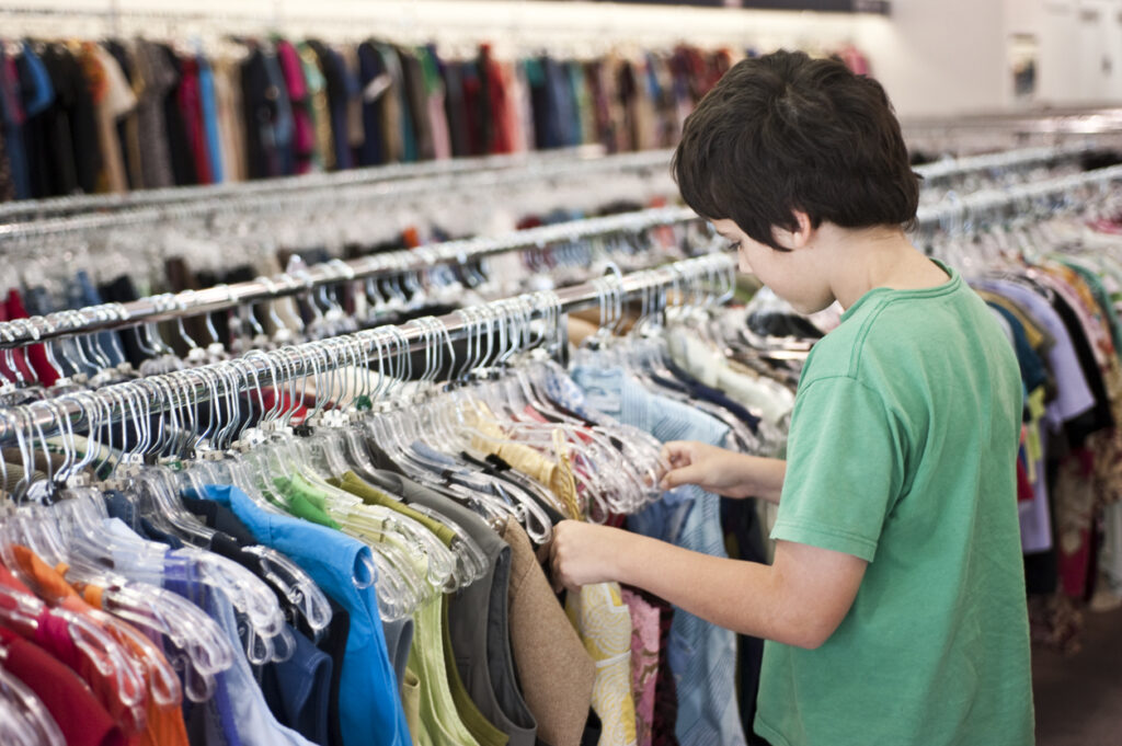 Child shopping for clothes in a thrift store