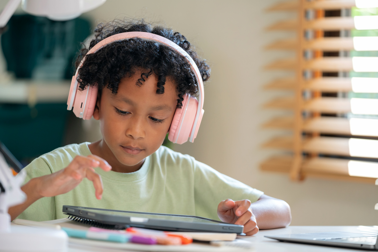 student with pink headphones on