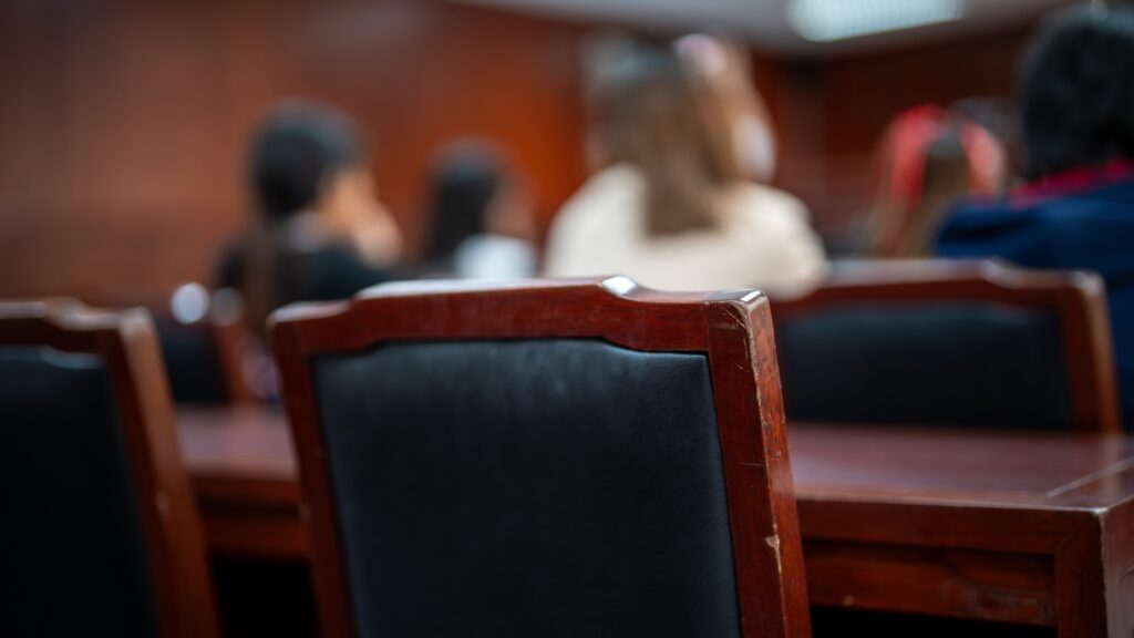 A group of people sitting in a court room