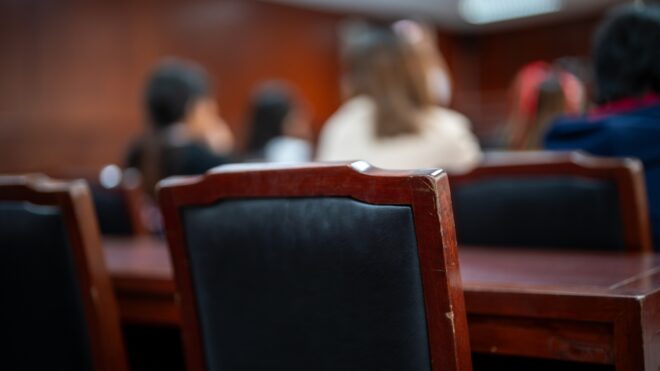A group of people sitting in a court room