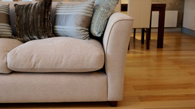 A stock photo of a modern-style sofa with pillows on top