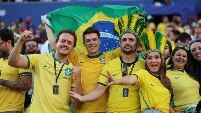 Brazilian fans pose with a flag before the FIFA World Cup 2026