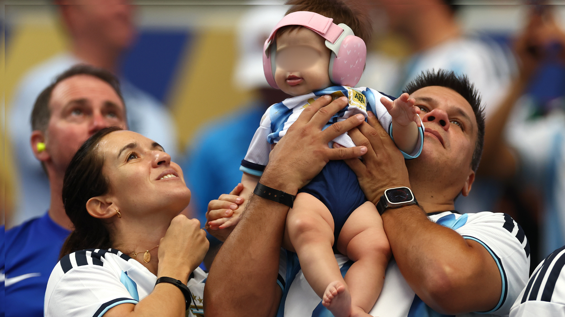 An Argentina fan holds a baby during the FIFA World Cup 2026