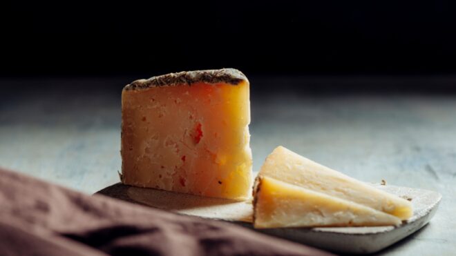 Two chunks of cheese on a board