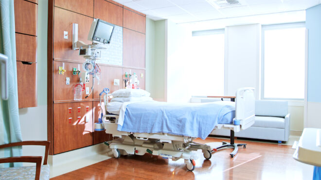 Private Room In Modern Hospital With Empty Bed And Medical Tech Equipment